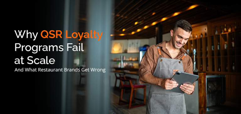Restaurant manager reviewing loyalty program data on tablet highlighting why QSR customer retention strategies fail at scale
